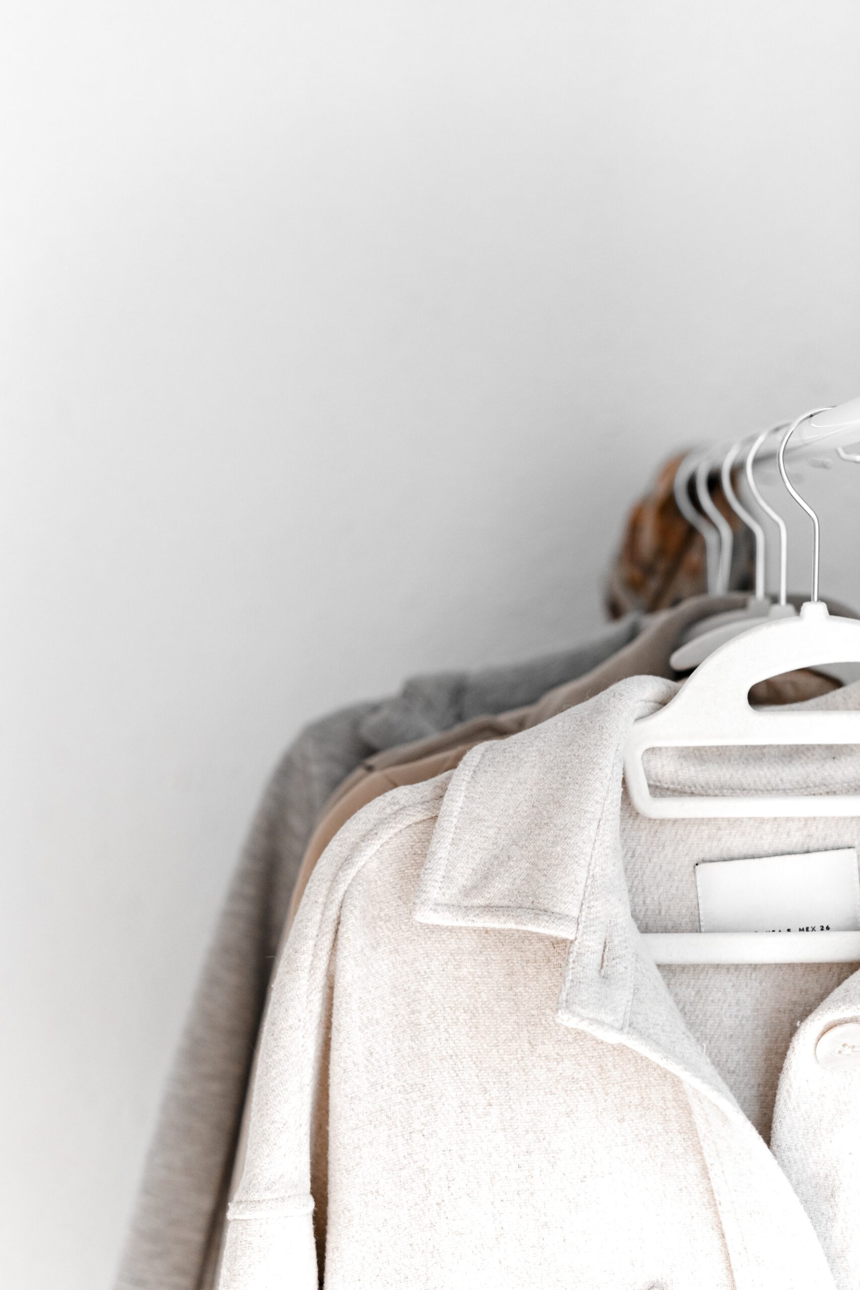 Neutral-toned garments on hangers